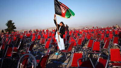 A supporter of Afghan presidential candidate Abdullah Abdullah holds an Afghan flag after an election campaign rally in the Paghman district of Kabul, in this June 9 file photo. Ahmad Masood / Reuters