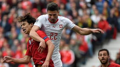 Switzerland's defender Fabian Schar (R) heads the ball with Portugal's midfielder Joao Felix during the UEFA Nations League semi-final. AFP