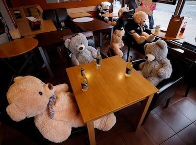 Teddy bears sit at tables in a British cafe after it was restricted to take-away sales only due to tightened Covid-19 restrictions. Reuters