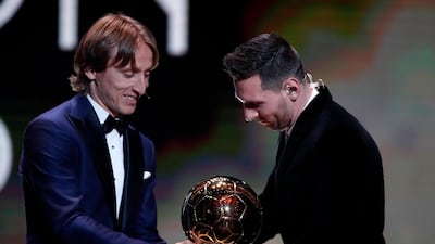 Barcelona's Lionel Messi, right, receives his sixth golden ball from Real Madrid's Lucas Modric during the Golden Ball award ceremony in Paris, Monday, December 2, 2019. AP Photo/Francois Mori