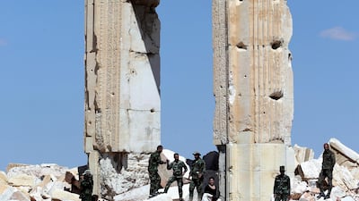 Syrian soldiers stand on March 31, 2016 on the ruins of Temple of Bel's "Cella", which was blown up by jihadists of the Islamic State (IS) group in August 2015, in the ancient Syrian city of Palmyra. AFP