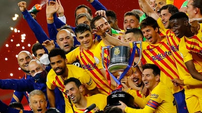 Barcelona's Lionel Messi lifts the trophy with celebrating teammates after winning the Copa Del Rey final against Athletic Bilbao. Getty