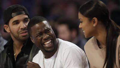 Actor Kevin Hart, centre, laughs as rapper Drake, left, looks on during the NBA All Star basketball game. Gerald Herbert / AP photo