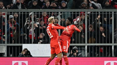 Eric Maxim Choupo-Moting, left, celebrates scoring Bayern's first goal with Alphonso Davies. Reuters