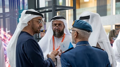Sheikh Mohamed talks to Lt Gen Issa Al Mazrouei, Chief of Staff of the UAE Armed Forces, and other officials at Idex