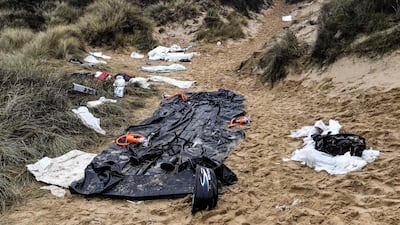 An inflatable boat, life vests and other remains left on a sand dune of the Wimereux beach, northern France. AFP
