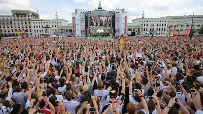 Fans cheer and celebrate as they wait for the arrival of the Germany's national team. Michael Kappeler / EPA