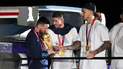 Lionel Messi with Rodrigo De Paul and Leandro Paredes. EPA