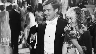 American actors Robert Redford, left, as Jay Gatsby, and Mia Farrow as Daisy Buchanan in a scene from The Great Gatsby, a 1974 film based on the novel by F Scott Fitzgerald. Paramount Pictures / Courtesy of Getty Images