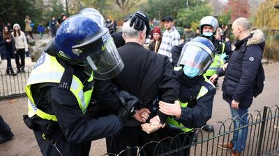 Police officers detain an anti-lockdown protestor during a demonstration amid the coronavirus disease (COVID-19) outbreak in London. Reuters