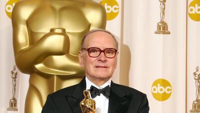 Italian composer Ennio Morricone poses with his Honorary Award Oscar at the 79th Academy Awards in Hollywood, California, on February 25, 2007. AFP