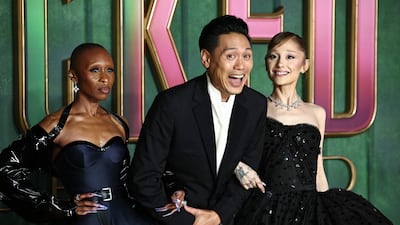 Actresses Cynthia Erivo, left, and Ariana Grande with director Jon M Chu on the red carpet at the European premiere of Wicked: For Good, in central London. AFP