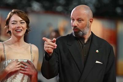 US actress Emma Stone with Greek director Yorgos Lanthimos on the red carpet before the screening of Bugonia. AFP