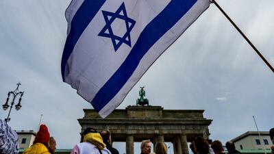 A demonstrator waves an Israeli flag during a rally in front of the Brandenburg Gate in Berlin. AFP