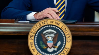 US President Joe Biden signs a bill limiting trade with Xinjiang, China, into law on Thursday. AP