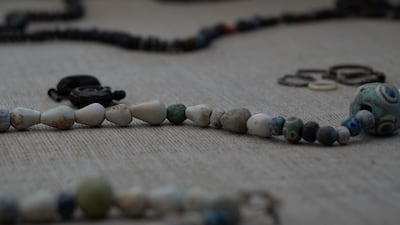 The finds, including necklaces, were displayed in a televised event on Monday at the Unesco Heritage site south of Cairo. Mahmoud Nasr / The National