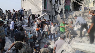 Rescuers at the scene of the strike on Shajarah Tayyebeh school in Minab, Iran. Reuters