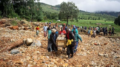 Men carry a coffin along a makeshift path on the river in Ngangu township Chimanimani, Manicaland Province, eastern Zimbabwe, after the area was hit by the cyclone Idai. AFP