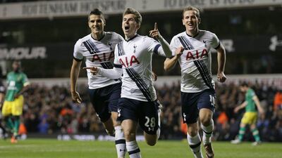 Tom Carroll of Spurs celebrates with Harry Kane and Erik Lamela after scoring against Norwich on Saturday. Tim Ireland / AP