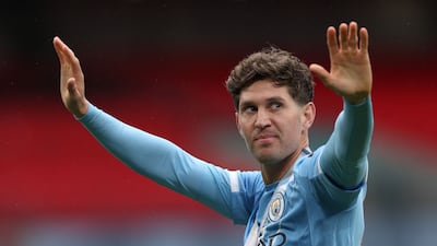 Manchester City's English defender John Stones greets fans after winning the FA Cup final against Chelsea at the Wembley Stadium. AFP
