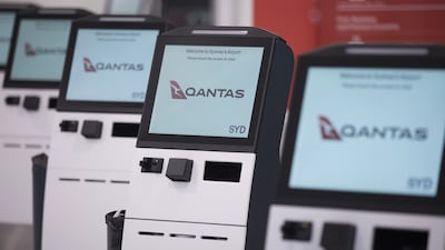 Qantas Airways' self check-in machines at Sydney Airport in Australia. The airline reported bumper profits on August 24. Bloomberg