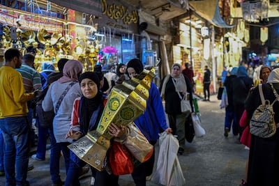 An woman carries a 'Fanous Ramadan' - a traditional decoration for the Muslim holy month, in central Cairo. AFP