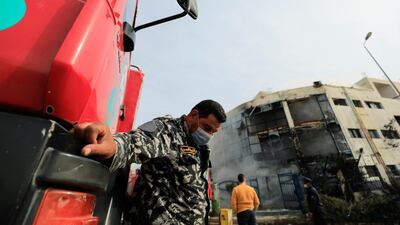 A policeman guards near firefighter truck at the scene after a fire broke out in a garment factory north of Cairo, Egypt. Reuters