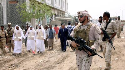 A UAE soldier escorts Yemeni prime minister Ahmed Obaid bin Daghar during a visit to the liberated Red Sea port city of Mokha on August 6, 2017. Fawaz Salman / Reuters