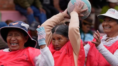 Members of the Indigenous Aymara people warm up before playing handball in El Alto, Bolivia. AP
