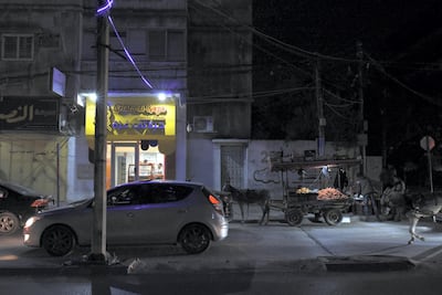 A fruit seller with his horse and cart stands next to the Gelato di Gaza shop on Al Nasser Street in Gaza City. Rosie Scammell for The National