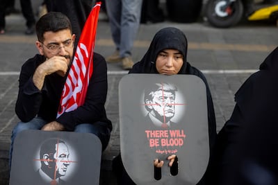 Mourners hold anti-Netanyahu and anti-Trump posters as they gather to pay final respects to Iran's former supreme leader Ayatollah Ali Khamenei in Tehran on July 6. Getty Images
