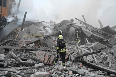 Emergency workers at the site of a Russian air strike on Kharkiv. AFP