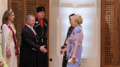 Jordan's King Abdullah II and Queen Rania greet Jill Biden, in Oscar de la Renta, and her daughter Ashley Biden at the royal wedding reception of Crown Prince Hussein and Rajwa Al Saif. Reuters