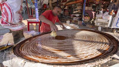 An Egyptian confectioner during Ramadan 2022. Food drives will launch three months early in 2023. AFP