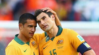 Tim Cahill, left, consoles Mile Jedinak after Australia's 3-2 loss to the Netherlands on Wednesday at the 2014 World Cup in Porto Alegre, Brazil. Cameron Spencer / Getty Images