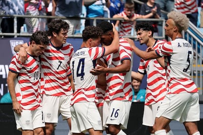 Christian Pulisic, centre, is mobbed after scoring against Senegal. AFP