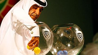 Rashed Amiri, of the Dubai Sports channel, draws balls to determine the groups for the 2011/12 Etisalat Cup yesterday.