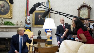 Donald Trump gestures while speaking to a member of the media during a meeting with Imran Khan in the Oval Office of the White House. Bloomberg