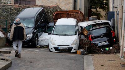 A man walks by piled up vehicles. EPA