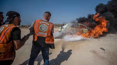 Firefighters battle a blaze after an Israeli military strike that killed a local police official in Gaza city on Thursday. EPA
