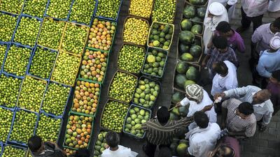 Ahmed, Oman: Ahmed showcases Al Buraimi’s seasonal fruits and vegetable market in this colourful shot as the seller auctions his produce to incoming buyers.
