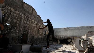 A member of a rebel group called the Martyr Al-Abbas throws a handmade weapon in Aleppo. The group consists of five brothers and other members and operate under the Free Syrian Army. Muzaffar Salman / Reuters