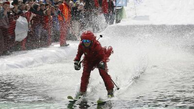 A skier tries to cross the pool at the Gornoluzhnik event. Ilya Naymushin / Reuters / April 20, 2014