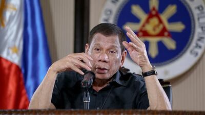Philippine President Rodrigo Duterte gestures as he addresses the nation during a live broadcast in Malacanang, Manila, Philippines. Mr Duterte is on quarantine for more than a week after meeting officials who have been exposed to people infected with the coronavirus. AP