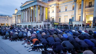 Muslims pray before an Open Iftar Ramadan dinner event in Trafalgar Square, London. EPA