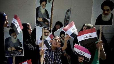 An Iraqi boy holds a picture of Iraq’s most senior Shiite cleric, Grand Ayatollah Ali Al Sistani as he attends a demonstration against the Islamic State – formerly known as the ISI – on the streets of Tehran on June 20, 2014. Maryam Rahmanian for The National