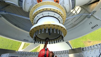 France is heavily reliant on nuclear energy, accounting for 75 per cent of its electricity. Above, a worker inside the rotor hub of an E-70 wind turbine being installed at a wind farm in Meneslies. Benoit Tessier / Reuters