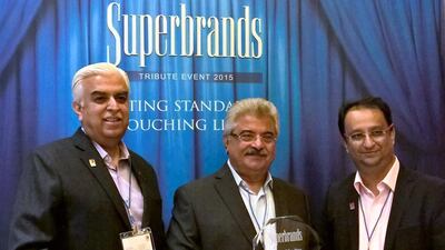 DJ Babani, the Eros Group chief executive, centre, celebrates with other officials after being named the Brand of the Year by Superbrands. Picture courtesy Sharon Divan
