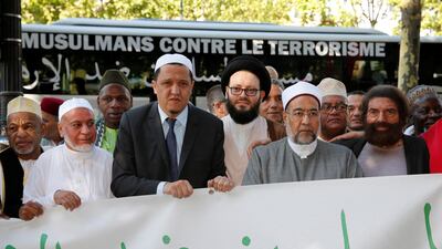 Jewish French writer Marek Halter (right) and Imam Hassen Chalghoumi (third left) are pictured with other Muslim leaders at the start of a European tour to the sites of recent Islamist attacks, on the Champs-Elysees in Paris on July 8, 2017. Pascal Rossignol / Reuters