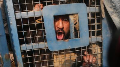 A member of the All Jammu and Kashmir Handicapped Association (AJKHA) shouts slogans inside a police vehicle after being detained by Indian police during a protest in Srinagar, Kashmir, India. According to media reports, police detained nearly a dozen members of AJKHA during their International Day of People with Disabilities rally, as they were carrying out a march demanding better living conditions and rights. Farooq Khan / EPA